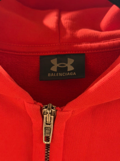 Red hoodie with Balenciaga label on a black background