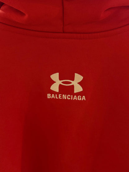 Red hoodie with Balenciaga logo on a plain background